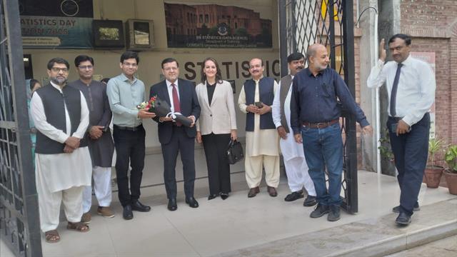The Head of Department presenting a gift to the Director at the department entrance