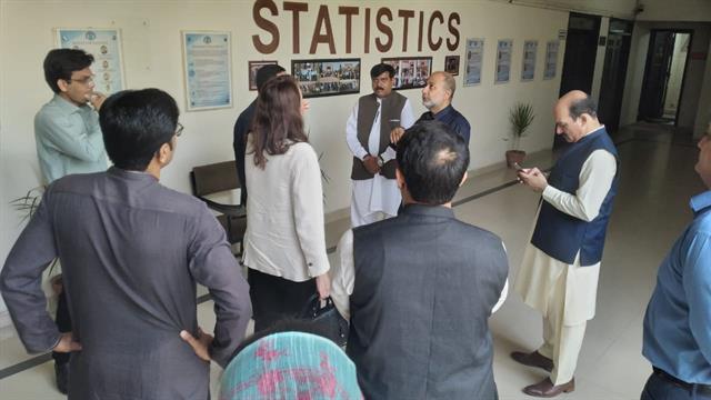 Faculty members with the Director in the department corridor
