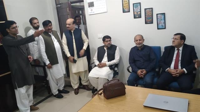A faculty member briefing the Director during the visit