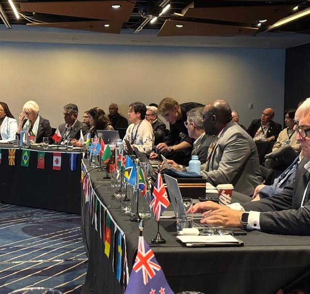The CAA Presidents' Summit in session, with national flags along the table