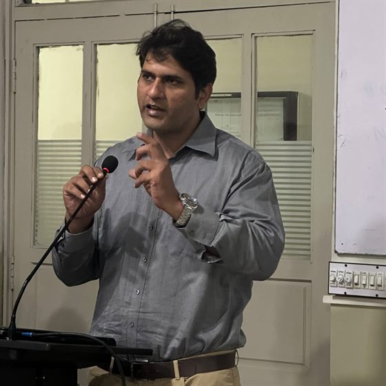 A speaker addressing the seminar from the lectern