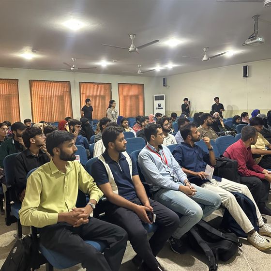 A full hall of students and young professionals at the seminar