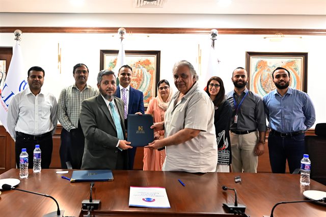 The signed memorandum of understanding being exchanged between CUI Lahore and the Indus Hospital and Health Network