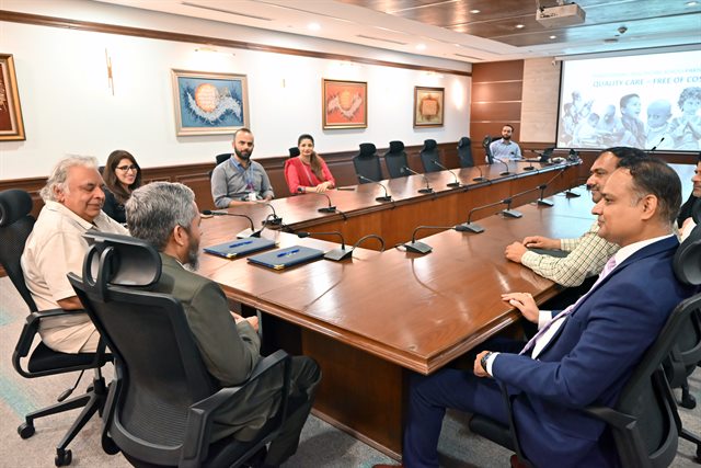 Members of both institutions in discussion around the boardroom table