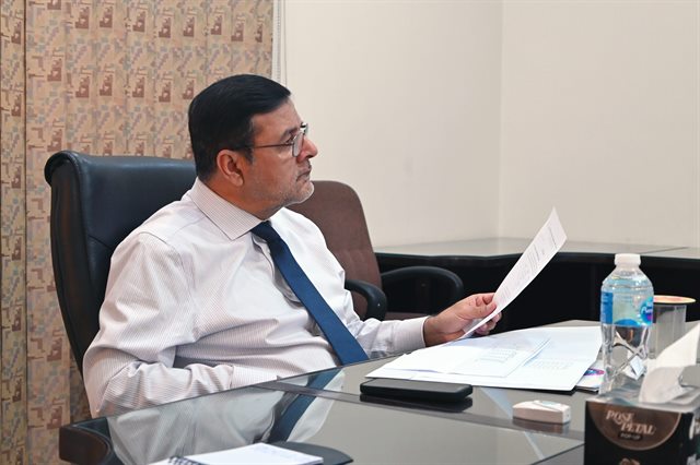 The Director reviewing documents during the day