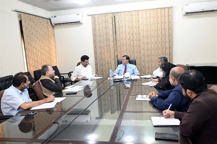 Members of the committee taking notes during the meeting