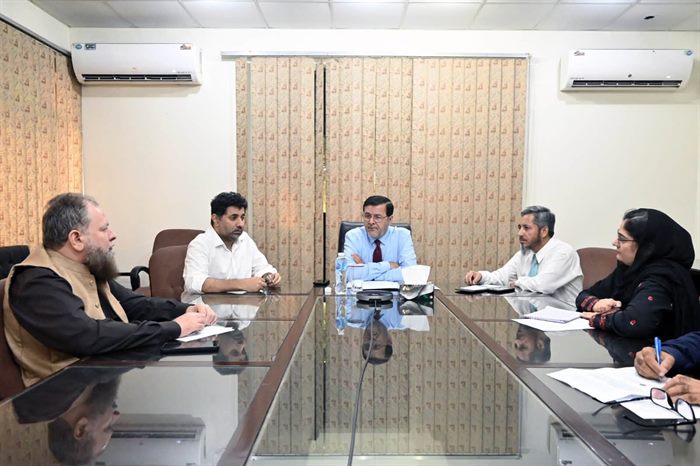 The Director chairing a meeting in the campus boardroom