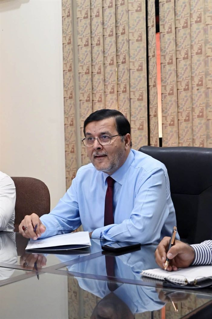 The Director at the head of the boardroom table