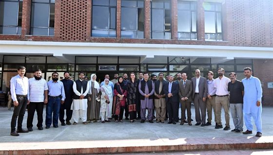 Prof. Dr. Qaisar Abbas with faculty members and colleagues outside a campus building