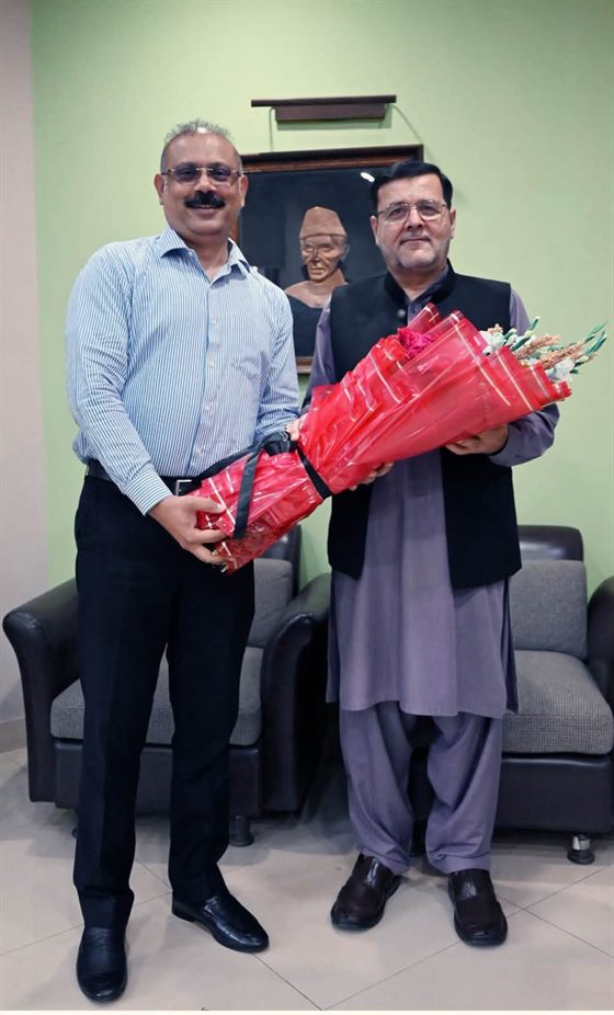 A visitor presented with a bouquet at the Director Secretariat