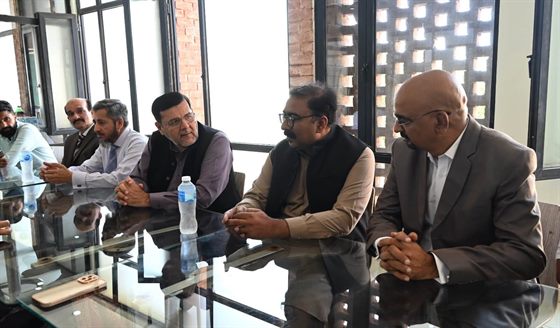 Faculty members and guests seated around the meeting table