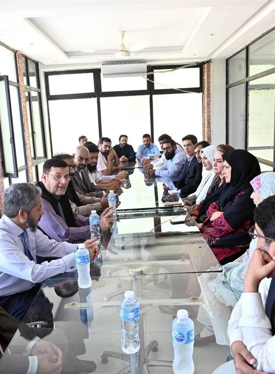 A meeting in progress in the campus boardroom