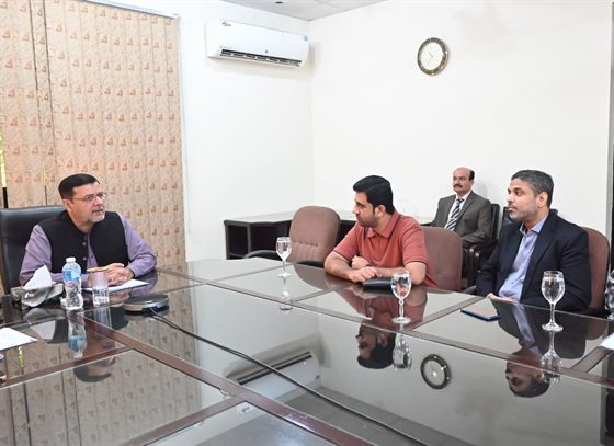 The Campus Director at the head of the meeting table