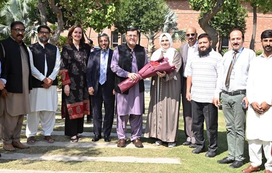 A group photograph with the Campus Director on the campus lawn