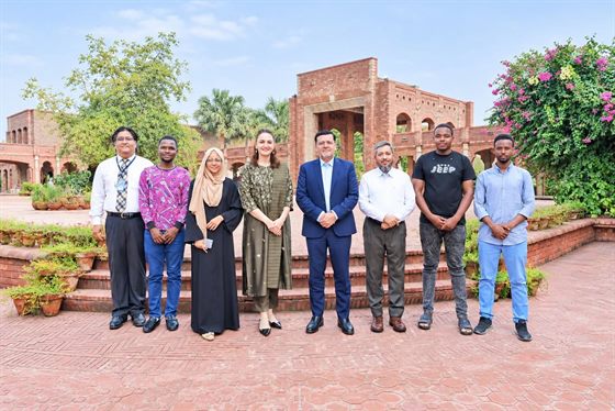 Prof. Dr. Qaisar Abbas with the four newly enrolled international students and colleagues on the campus