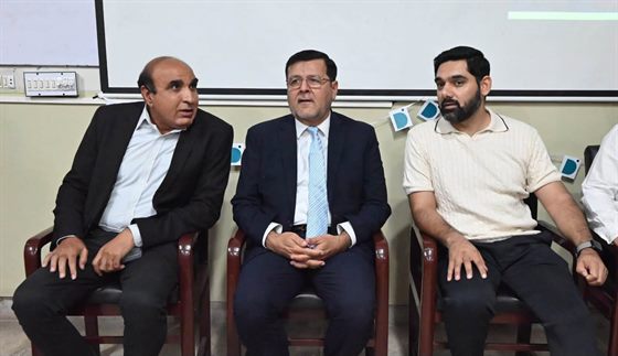 The Campus Director seated with the visiting speaker