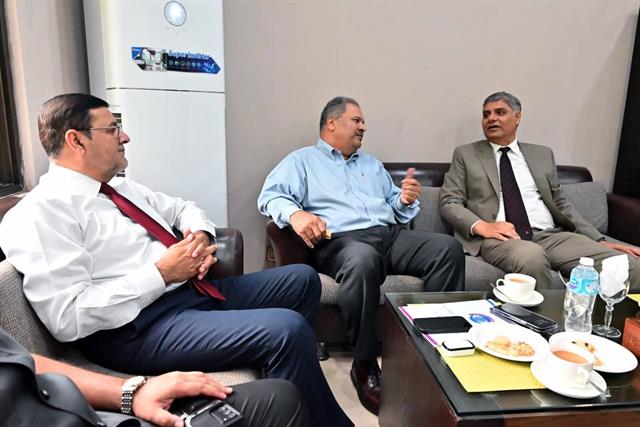 The Director in discussion with guests during a meeting