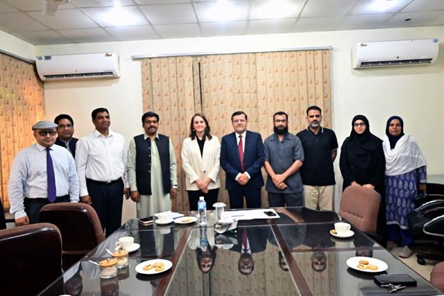 The Director with faculty members in a department meeting room