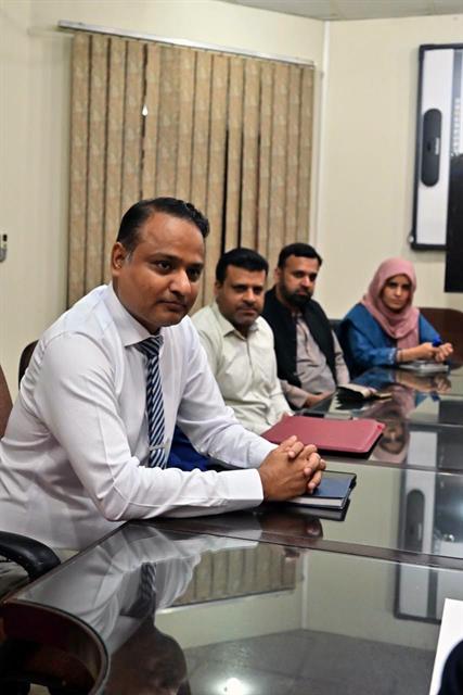 Faculty members seated at the table during an introductory meeting