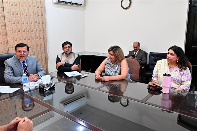 Faculty members listening to the Director