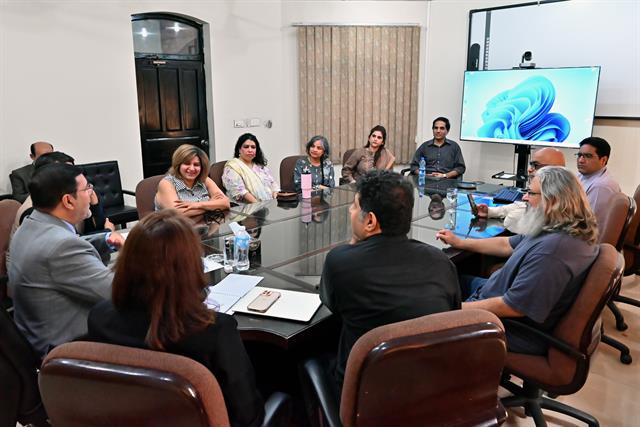 Faculty members seated around the boardroom table