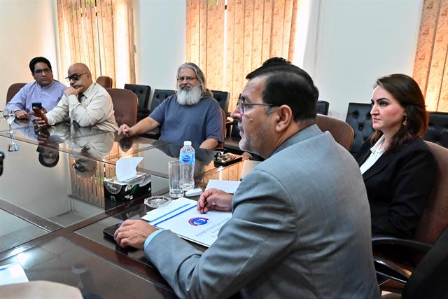 The Director in conversation with a department