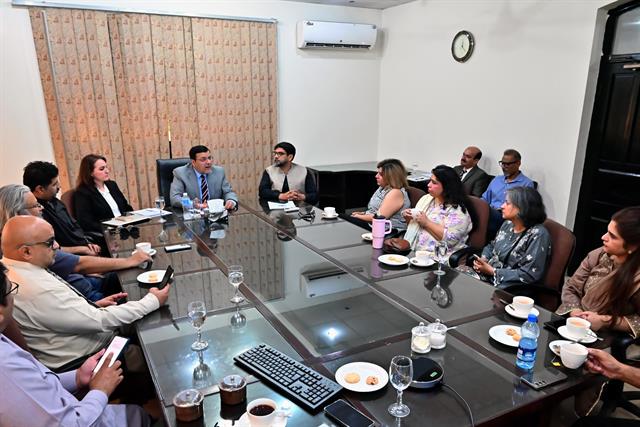 A full boardroom meeting with faculty members