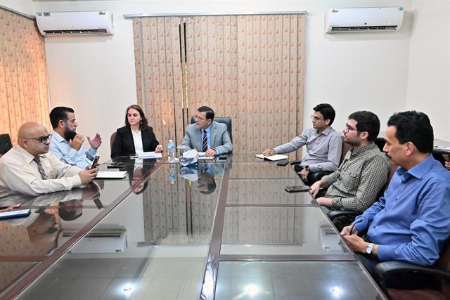 Faculty members at a meeting with the Director
