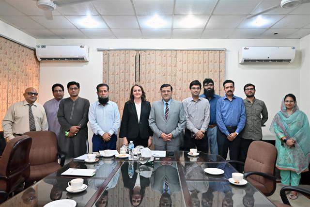 The Director with a department's faculty members in the boardroom