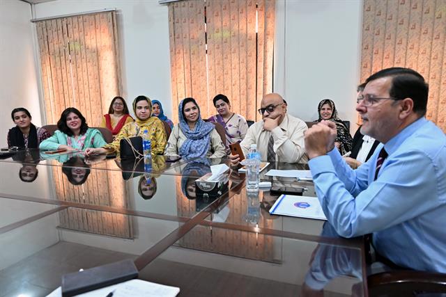 The Director addressing a group of faculty members