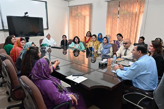 Faculty members in a meeting with the Director