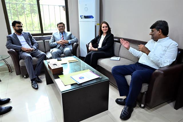 The Director meeting faculty members in a department office