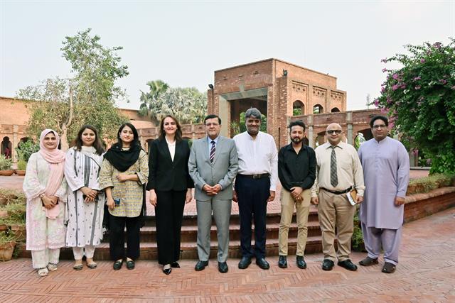 The Director with a department's faculty members outside the campus building