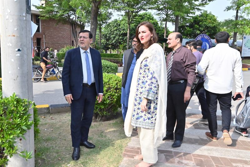 The Director walking across the campus with colleagues