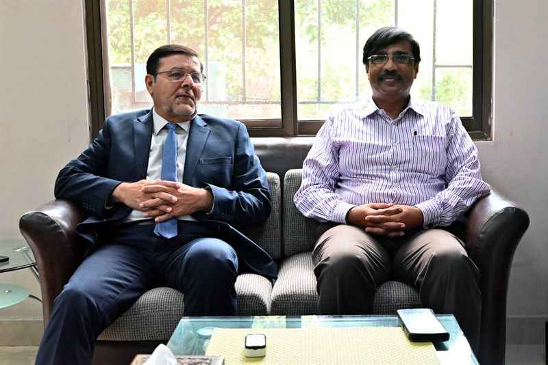 The Director seated with a visitor at the Directorate