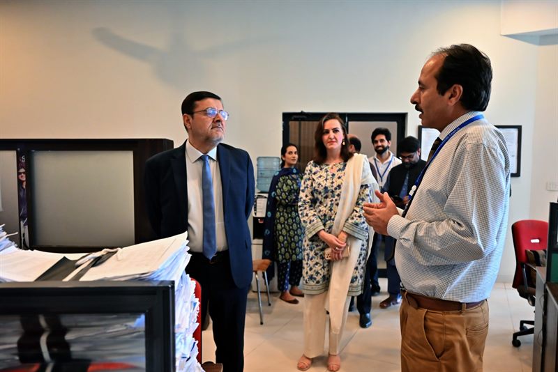 A member of staff briefing the Director at the Student Services Centre