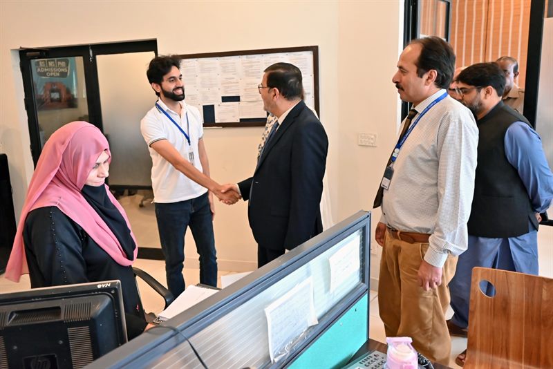 Prof. Dr. Qaisar Abbas meeting a student at the Student Services Centre, CUI Lahore Campus
