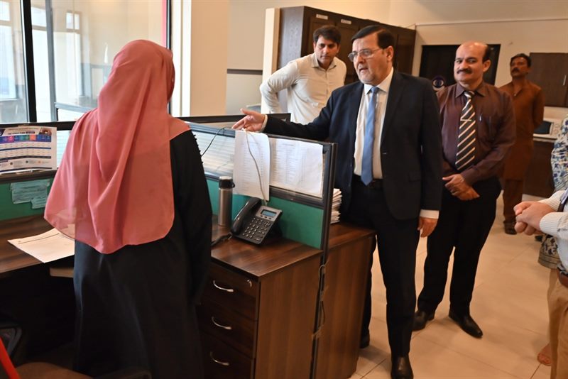 The Director in conversation with staff at the front desk