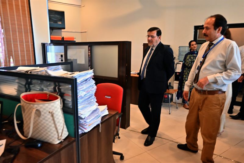 The Director reviewing files and records at the Student Services Centre
