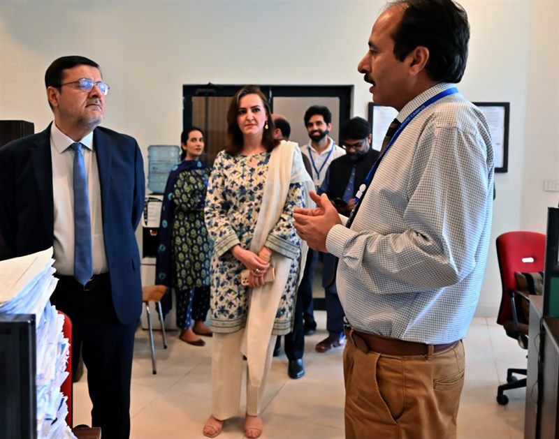 Staff explaining the Centre's operations to the Director