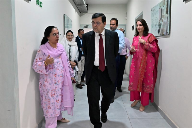 The Director walking through the laboratory corridor with faculty members