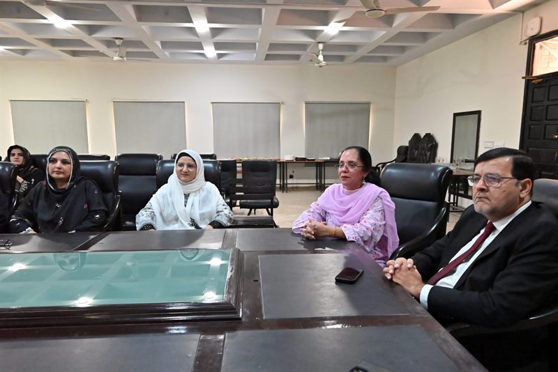 The Director seated with faculty members during the meeting