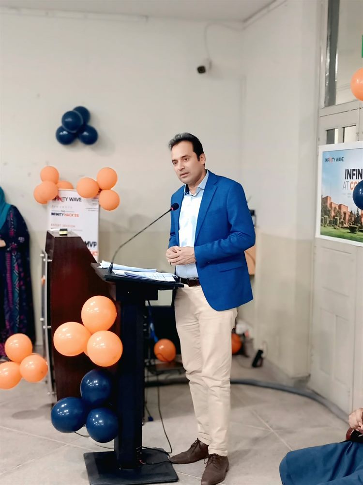 A speaker addressing participants from the rostrum