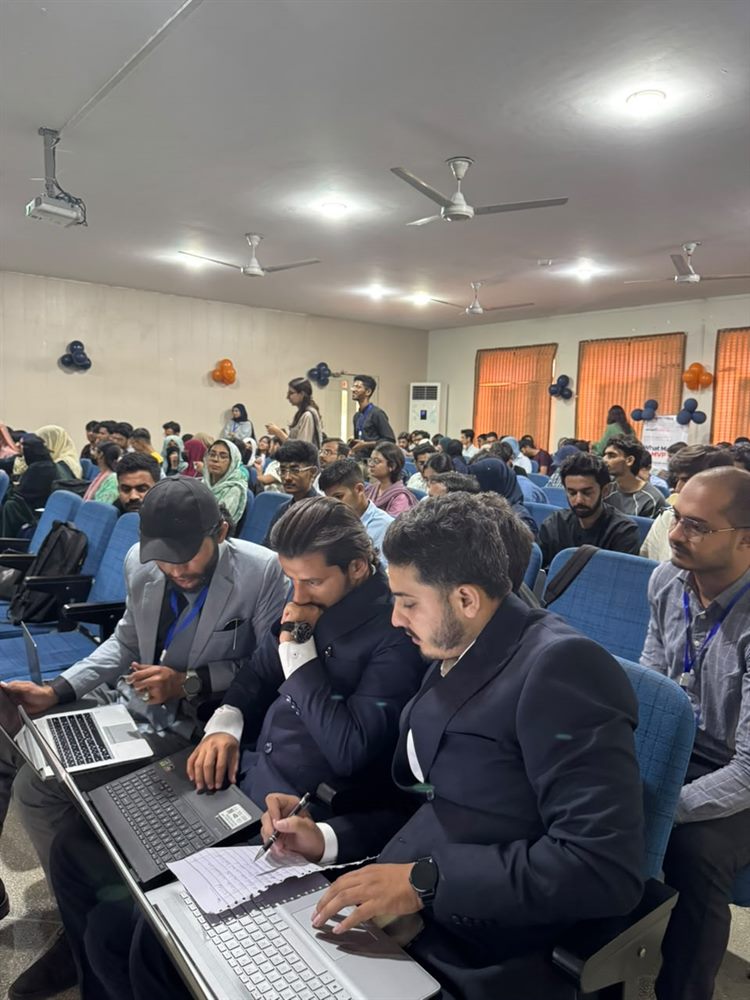 Participants working through the hackathon challenge on their laptops