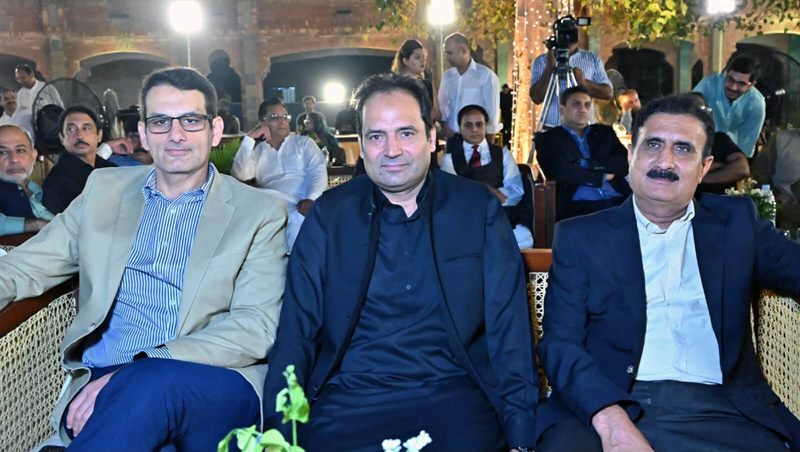 Guests seated in the lit courtyard at the Lahore Campus