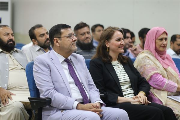 Faculty members, officers and staff seated at the promotion ceremony