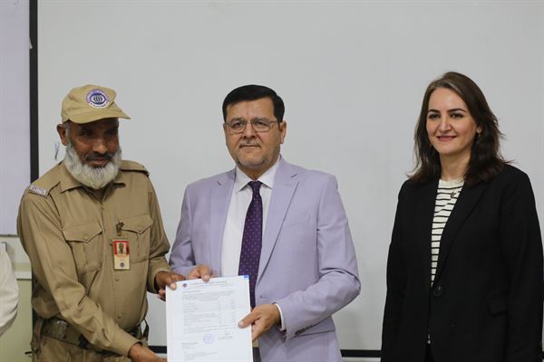 A member of the security staff receiving his promotion letter