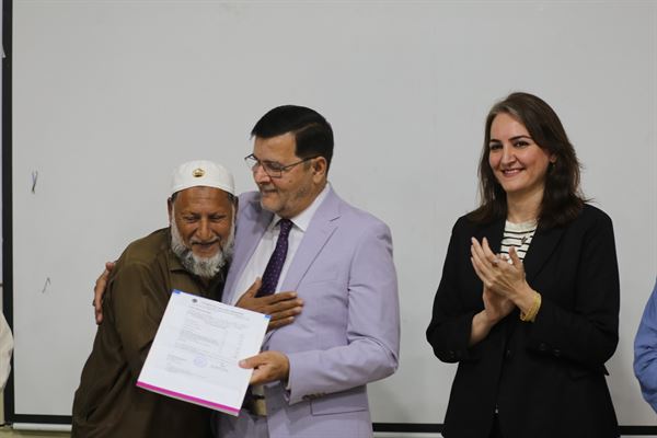 A senior colleague embraced by the Director on receiving his letter