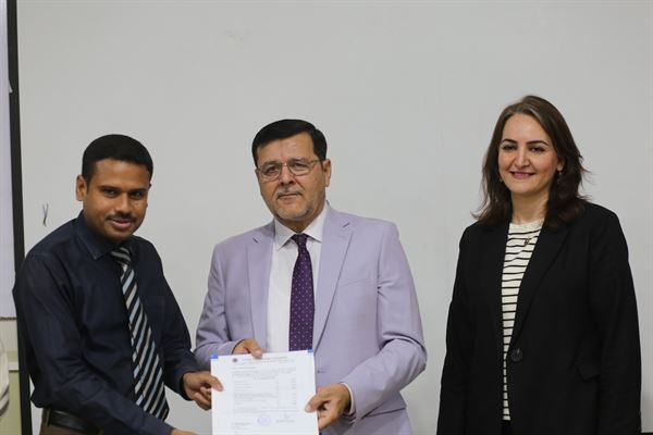 A colleague with the Director at the promotion ceremony