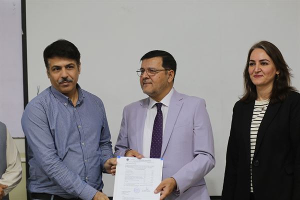 A staff member receiving his letter from the Director